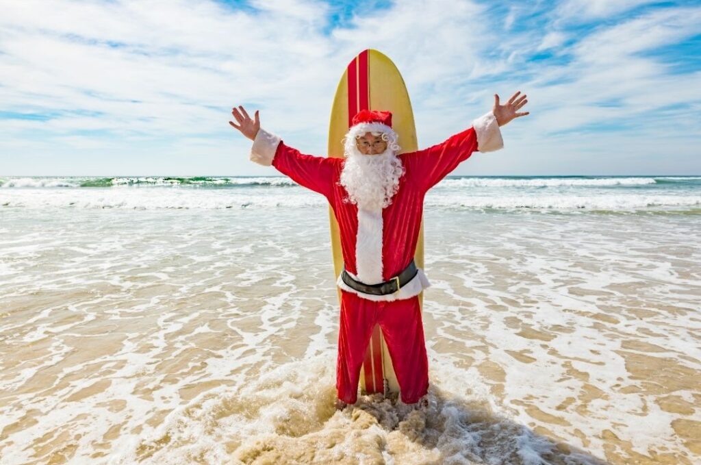 Santa in front of a surf board on Isle of Palms